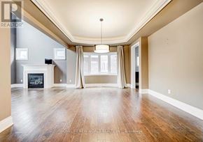 Aurora apartment for rent - A spacious living room with wood flooring and a fireplace.