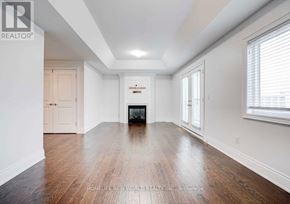 Aurora apartment for rent - A room with wooden floors and white walls, with a door on the left and a window on the right.