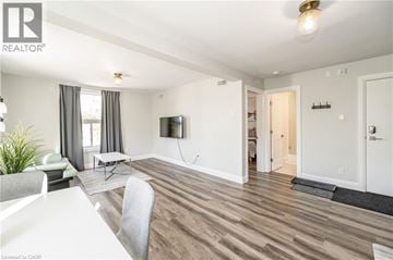 Kitchener apartment for rent - A living room with a white table and grey chairs.