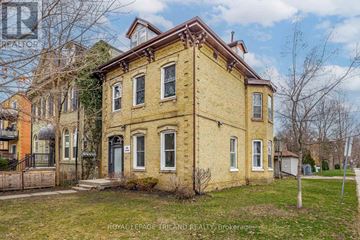 London East (East F) multi-family for rent - A yellow brick house with a black gate in front.