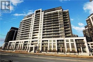 Toronto (York University Heights) condo for rent - A large, multi-story residential building with a flat roof and a balcony on the second floor.