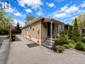 Toronto (Thistletown-Beaumonde Heights) apartment for rent - A house with a red roof and a driveway in front of it.
