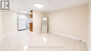 Toronto (Thistletown-Beaumonde Heights) apartment for rent - A spacious room with a refrigerator and a freezer in it.