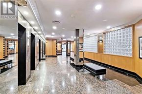 Toronto (Willowdale East) condo for rent - A long hallway with a marble floor and benches on either side.