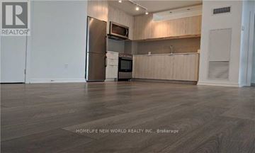 Toronto (Henry Farm) condo for rent - A kitchen with wooden cabinets and a refrigerator.
