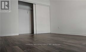 Toronto (Henry Farm) condo for rent - A room with a sliding door and wooden flooring.