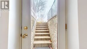 Guelph (Kortright West) apartment for rent - A white door with a gold handle and a set of stairs leading up to it.