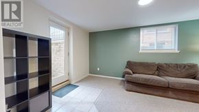 Guelph (Kortright West) apartment for rent - A living room with a couch and a bookshelf.