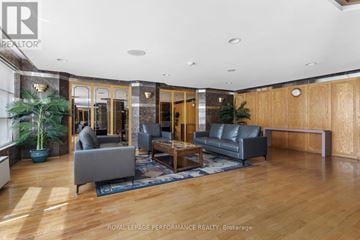 Ottawa condo for rent - A living room with a grey couch and a wooden floor.
