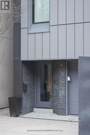 Toronto (Annex) apartment for rent - A modern building with a grey facade and a door numbered 41.
