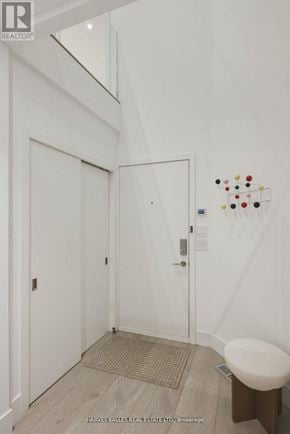 Toronto (Annex) apartment for rent - A white door with a handle and a small round table next to it.