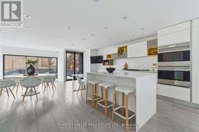 Toronto (Annex) apartment for rent - A modern kitchen with white cabinets and a bar area.