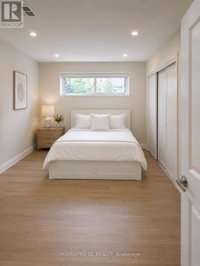 Richmond Hill (Harding) apartment for rent - A bedroom with a bed, nightstand, and a window.