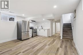 Hamilton (Parkview) apartment for rent - A kitchen with a refrigerator, microwave, and oven is shown in a real estate listing.