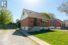 Sarnia apartment for rent - A house with a red brick exterior and a white trim is shown.
