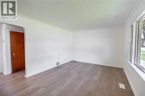 Sarnia apartment for rent - A room with a wooden floor and a door on the left side.