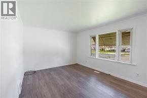 Sarnia apartment for rent - A room with a window and wooden flooring.