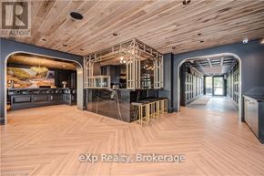 Centre Wellington (Elora/Salem) condo for rent - A modern interior space with wooden floors and exposed beams.