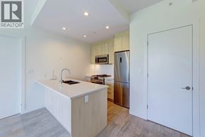 Burnaby apartment for rent - A kitchen with a white countertop and a stainless steel refrigerator.