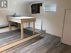Burnaby apartment for rent - A room with a wooden table and a window with blinds.