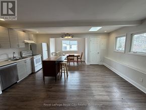 Guelph (Exhibition Park) apartment for rent - A kitchen with wooden floors and white walls.