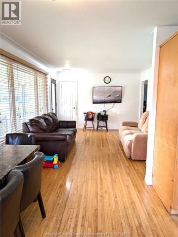 Windsor apartment for rent - A living room with a black leather couch and a wooden floor.