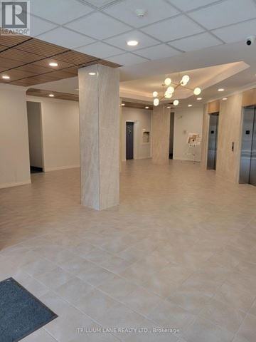 Toronto (Leaside) condo for rent - A spacious office hallway with a wooden floor and white walls.