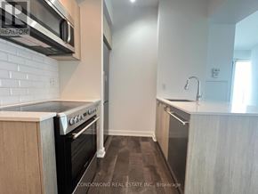Toronto (Church-Yonge Corridor) condo for rent - A kitchen with a white brick backsplash and a stove top oven.