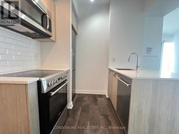Toronto (Church-Yonge Corridor) condo for rent - A kitchen with a white brick backsplash and a stove top oven.