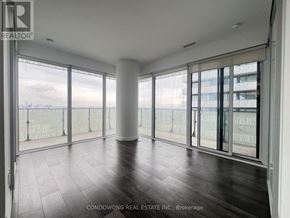 Toronto (Church-Yonge Corridor) condo for rent - A spacious room with a view of the city through large windows.