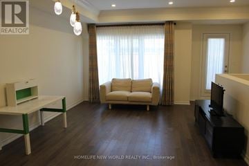 Toronto (L'amoreaux) townhouse for rent - A living room with a white sofa and a black entertainment center.