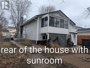 St. John's multi-family for rent - A house with a sunroom is shown in the image.