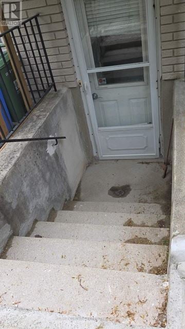London North (North H) apartment for rent - A kitchen with white cabinets and a red chair.