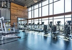Waterloo condo for rent - A gym with a variety of equipment including treadmills, weights, and exercise machines.