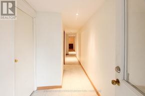 Toronto (Bayview Woods-Steeles) apartment for rent - A hallway with white walls and a wooden floor.