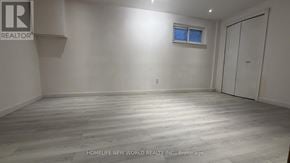 Toronto (Bayview Woods-Steeles) apartment for rent - A room with a wooden floor and a window with a white wall.