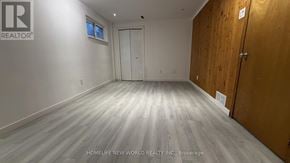 Toronto (Bayview Woods-Steeles) apartment for rent - A room with a wooden floor and a white door.