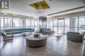 Toronto (Bendale) condo for rent - A large, open living room with a chandelier and a variety of seating options.