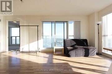Toronto (Bendale) condo for rent - A living room with a couch and a large window.