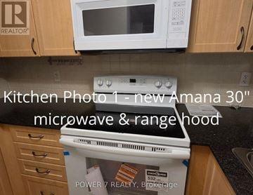 Markham (Unionville) condo for rent - A kitchen with a new Amana 30" microwave and rangehood.