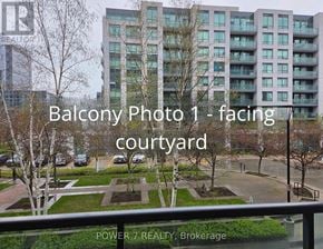 Markham (Unionville) condo for rent - A view of a courtyard from a balcony with a building in the background.