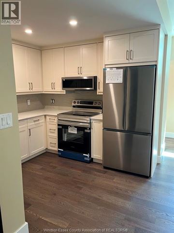 Lasalle apartment for rent - A kitchen with a stainless steel refrigerator and a microwave above the stove.
