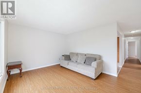 Welland (N. Welland) apartment for rent - A living room with a grey couch and wooden floors.