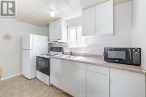 Welland (N. Welland) apartment for rent - A kitchen with white cabinets and appliances.
