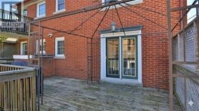 Kitchener apartment for rent - A brick building with a glass door and windows.
