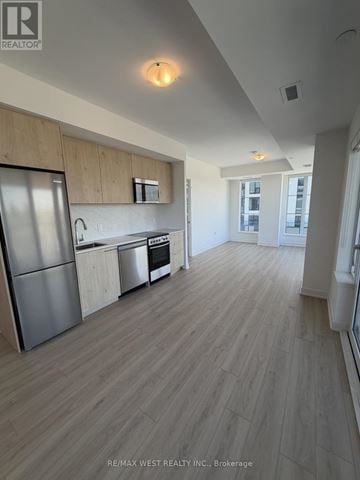Toronto (Rouge) condo for rent - A kitchen with a refrigerator, oven, and sink.