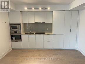 Toronto (Bay Street Corridor) condo for rent - A kitchen with white cabinets and a microwave oven.