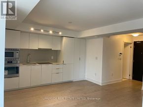 Toronto (Bay Street Corridor) condo for rent - A kitchen with white cabinets and a sink.