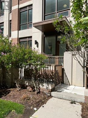 Toronto (Forest Hill South) house for rent - A building with a brown and beige facade has a tree in front of it.