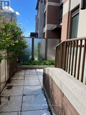 Toronto (Forest Hill South) house for rent - A view of a building with a balcony and a tree in the foreground.
